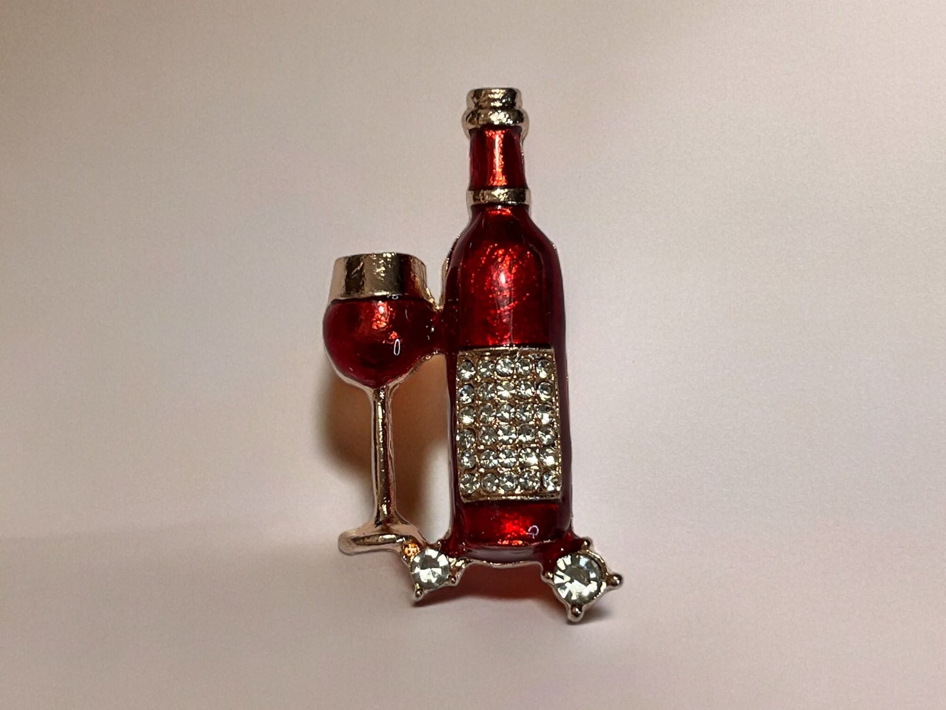 Sparkling rhinestone wine bottle and wine, glass metal brooch. Gold and red.