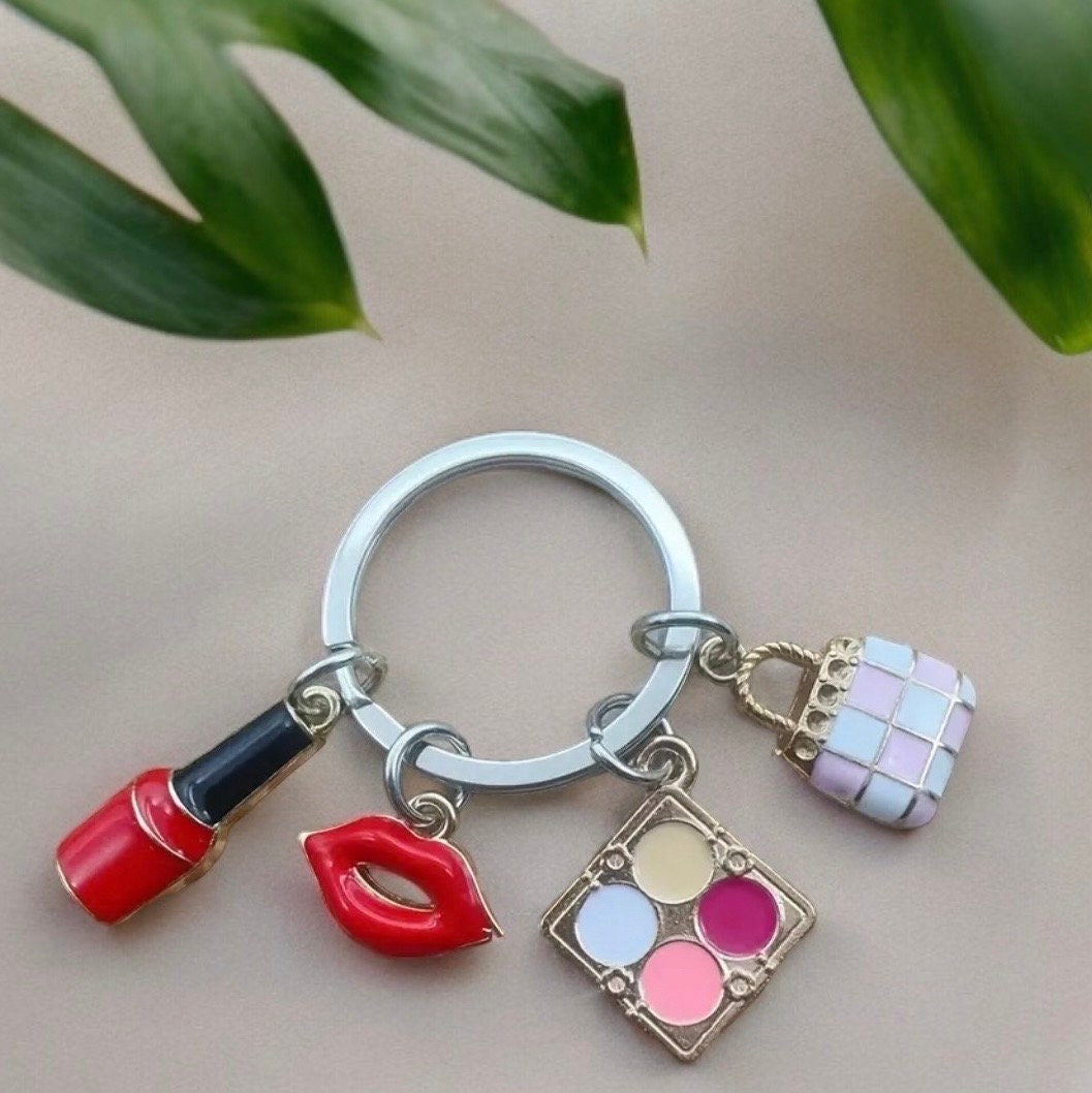 Nail Polish, Red Lips, Eye Shadow, Purse, Pendant Keychain is a stylish and practical accessory for anyone who loves to accessorize.