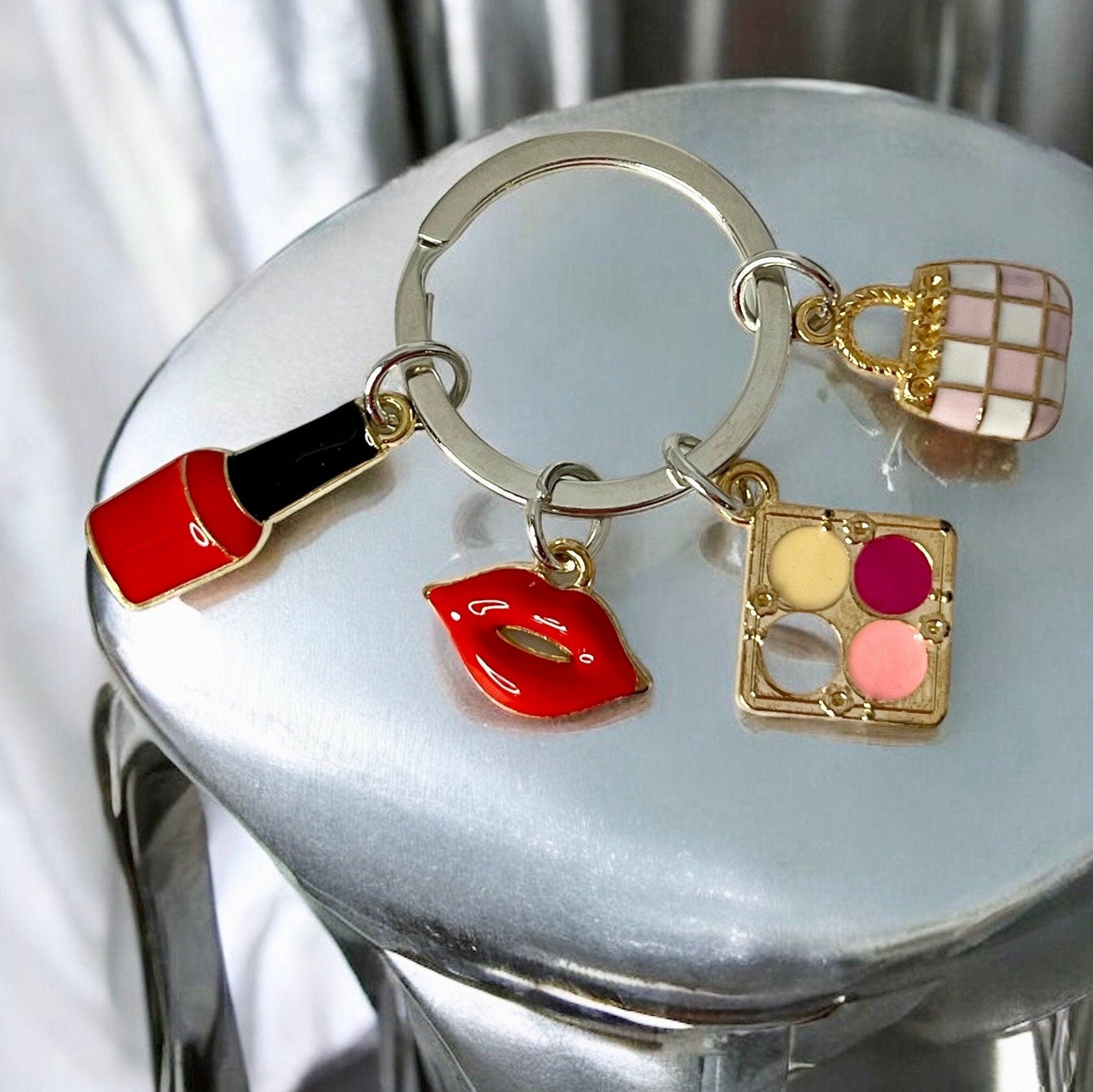 Nail Polish, Red Lips, Eye Shadow, Purse, Pendant Keychain is a stylish and practical accessory for anyone who loves to accessorize.