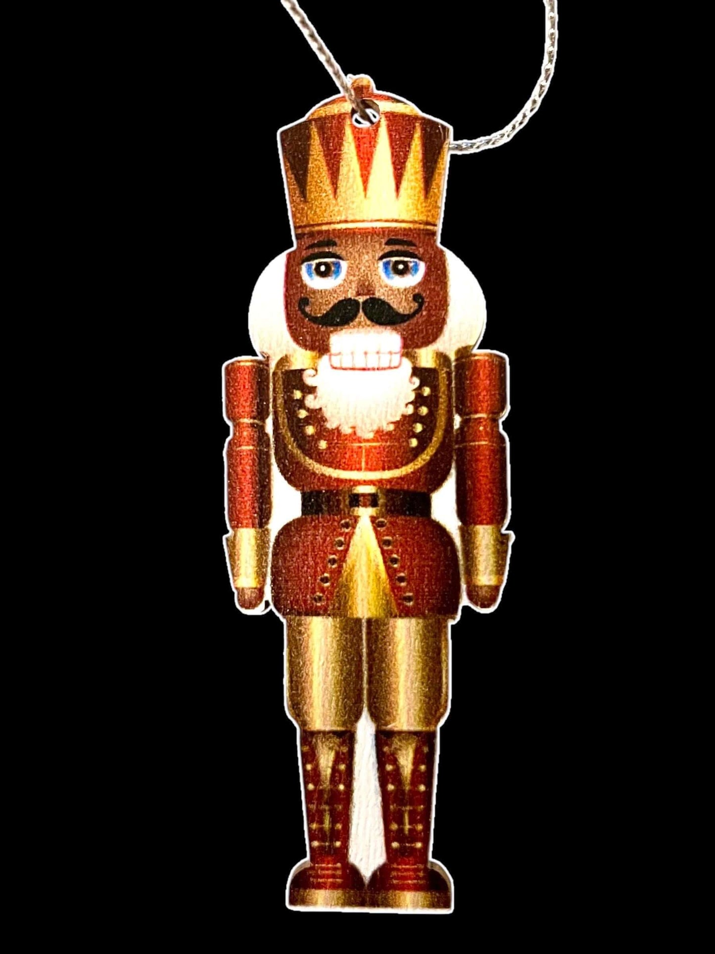 Vintage-inspired King Nutcracker ornament with a golden crown and red uniform hanging against a black background